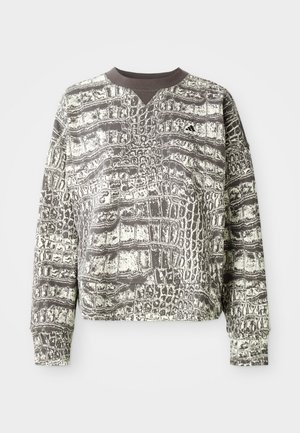 Long-sleeve crewneck sweatshirt with black and white alligator-scale pattern and small Adidas logo on left chest.