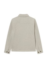 Beige kordfløjljakke med lange ærmer, krave og knapmanchetter. Har en diskret ribbet tekstur og en rygdetalje.