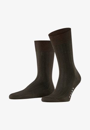 Chaussettes côtelées marron foncé avec une bordure côtelée marron clair, une pointe sans couture et un motif de marque subtil au niveau de la cheville.