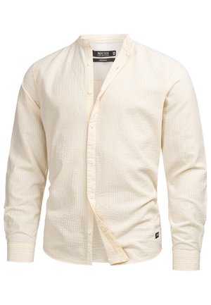 Camicia giallo chiaro in tessuto testurizzato con sottili strisce orizzontali. Presenta un colletto a fascia, maniche lunghe e chiusura con bottoni.