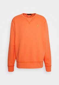 Orange sweatshirt i mjuk bomull, med ribbad rund halsringning, långa ärmar och en liten grön logotyp på bröstet.