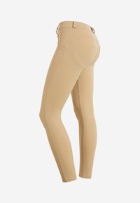 Leggings beige con una texture liscia e elastica. Presentano una vita alta, cuciture sottili e tasche posteriori curve.