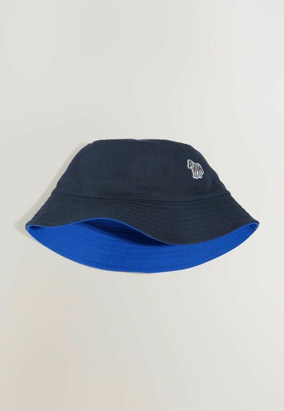 Chapeau bob réversible avec un extérieur bleu foncé, un intérieur bleu vif et un petit logo zèbre brodé multicolore sur le côté.