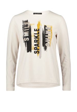 Kremowa koszulka z długim rękawem i okrągłym dekoltem, z czarno-złotym tekstowym wzorem "Smile Sparkle Shine".