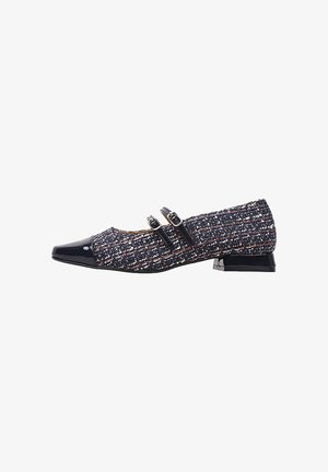 Zapato plano con parte superior de tela texturizada en azul marino con motas de colores múltiples, puntera de charol negra y dos correas decorativas.