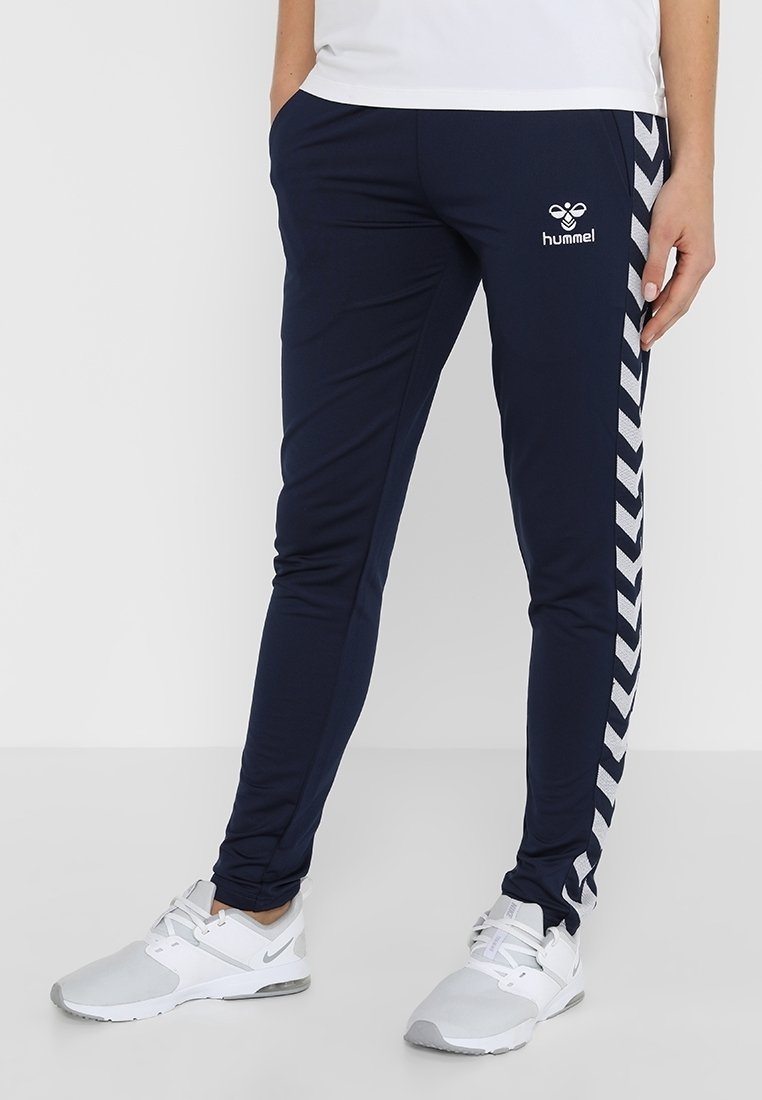 Marinefarbene Sporthosen aus dehnbarem Material, mit einem weißen Zickzackmuster an den Seiten und einem Logo auf der Vorderseite.