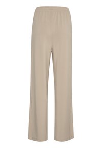 Pantalon beige à jambes larges en matière douce, avec une taille élastique et sans poches visibles, conçu pour le confort et la facilité de port.