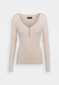 Beige-värinen, ribbineulottu pitkähihainen neule, jossa on V-pääntie ja viisi pientä ruskeaa nappia etupuolella keskellä.