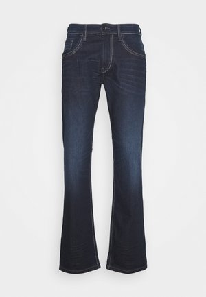 Mörkblå denimjeans med utsvängd benform, med kontrasterande vit sömnad, knappstängning och femfickdesign.