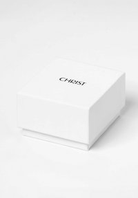 Hvid rektangulær gaveæske med en glat overflade, der har ordet "CHRIST" trykt i sort på den øverste flade.