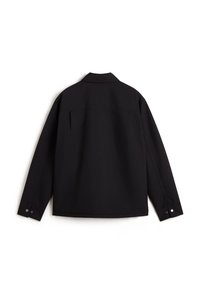 Veste noire à manches longues avec col, poignets boutonnés et dos droit, posée à plat sur un fond blanc.