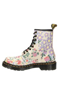 Floral-patterned lace-up boots with a beige synthetic upper, black sole, and yellow stitching. Features various colored flowers and a pull tab.