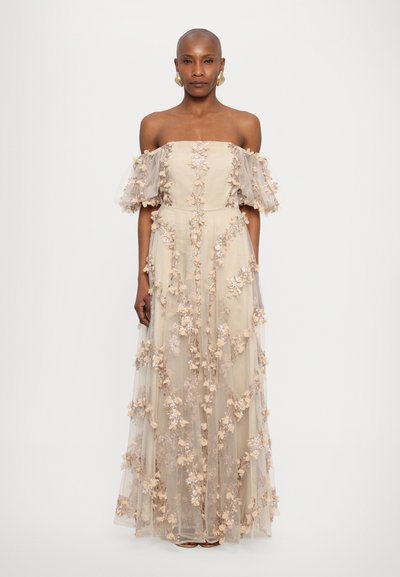 Off-the-shoulder, floor-length dress in light beige with sheer filmy sleeves and floral embroidery in soft pink and purple.