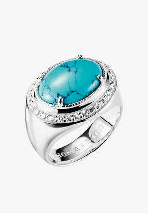 Silberner Ring mit großem ovalem Türkisstein in der Mitte, umgeben von kleinen klaren Kristallen in einer runden Fassung.