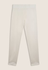 Pantalons couleur crème avec une taille élastique texturée et des poignets côtelés. Fabriqués dans un matériau doux, avec une coupe droite.