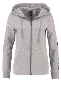 Sweat à capuche gris avec une fermeture éclair frontale, un cordon de serrage à la capuche et des poches latérales. Présente un logo accent marine sur la manche gauche.