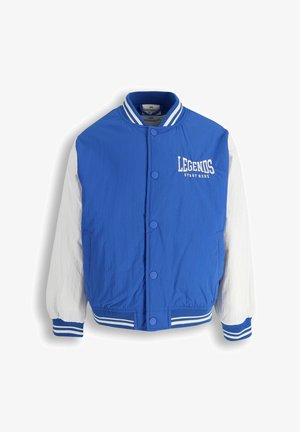 Niebiesko-biała kurtka drużynowa z zatrzaskami, prążkowanym kołnierzem i mankietami oraz napisem „LEGENDS START HERE” na piersi.