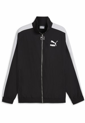 Mustapullo takki, jossa on korkea kaulus, valkoiset olkapäätä korostavat raidat, elastiset hihansuut ja helma; takissa on valkoinen logo vasemmassa rintapielessä.