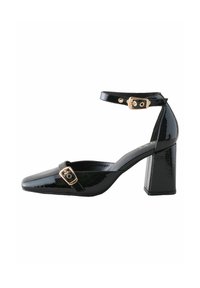 Black patent leather high-heeled shoe with a square toe, ankle strap, and gold buckle accent on the strap. Block heel design.