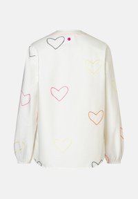 White long-sleeve shirt with multicolored embroidered heart outlines scattered on back and sleeves, featuring a small pink button near the collar.
