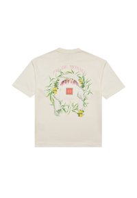 Camicia beige a maniche corte con una corona floreale e di limoni che circonda un arco con la scritta "PAS DE MONACO" sopra.