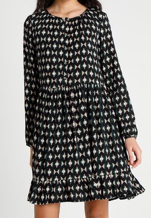 Zwart lange mouw jurk met een geometrisch patroon in wit, roze en teal. Heeft een gathered halslijn en een gerimpelde zoom.