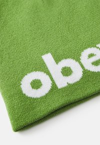 Green textile with a smooth texture, featuring the word "ober" in bold white knit lettering across the surface.