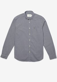 Nappikauluksellinen pitkähihaispaita, jossa laivastonsininen ja valkoinen ruutukuosi, rintatasku ja vasemmalla puolella vihreä logokuvio.