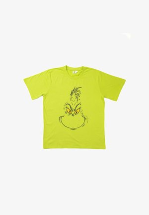 T-shirt verde brillante a maniche corte con un grande viso illustrato del Grinch in nero e giallo, centrato sulla parte anteriore.