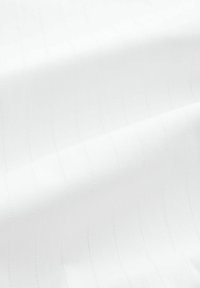 White fabric with subtle vertical stripes and a smooth texture. Stitching lines are visible, showcasing a clean design and even surface.