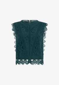 Top verde oscuro sin mangas con encaje, escote alto, bordes en forma de ondas, patrón floral y cierre trasero con cremallera.