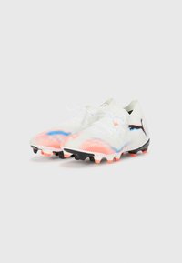 White soccer cleats with pink and blue gradient patterns, lightweight design, textured upper, black studs, and white laces.