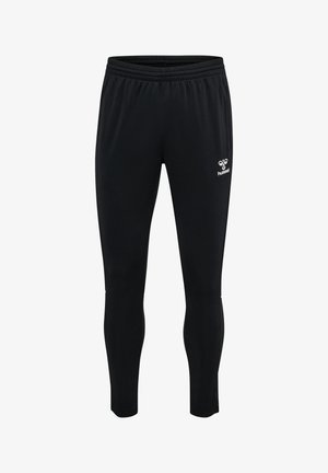 Pantalones deportivos ajustados negros con cintura elástica y logo blanco de Hummel en la parte superior izquierda de la pierna.