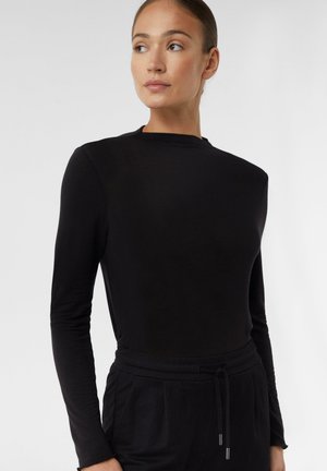 Black long-sleeve top with a rounded neckline, smooth texture, and a slim fit. Paired with black drawstring trousers. Simple design and monochrome color.