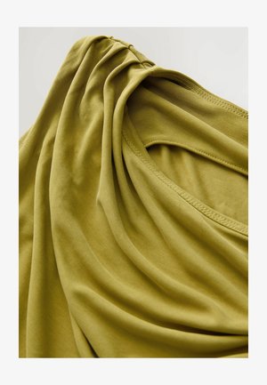 Linen top in muted olive green, featuring soft draping, a rounded neckline, and smooth texture. Pleats near the shoulder add dimension.