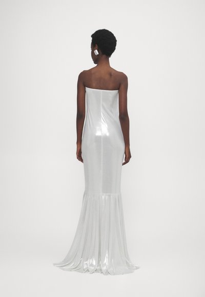 Trägerloses silbernes Kleid mit enganliegendem Oberteil und ausgestelltem Saum. Der Stoff ist glänzend und glatt und hat am Saum eine gefaltete Textur.