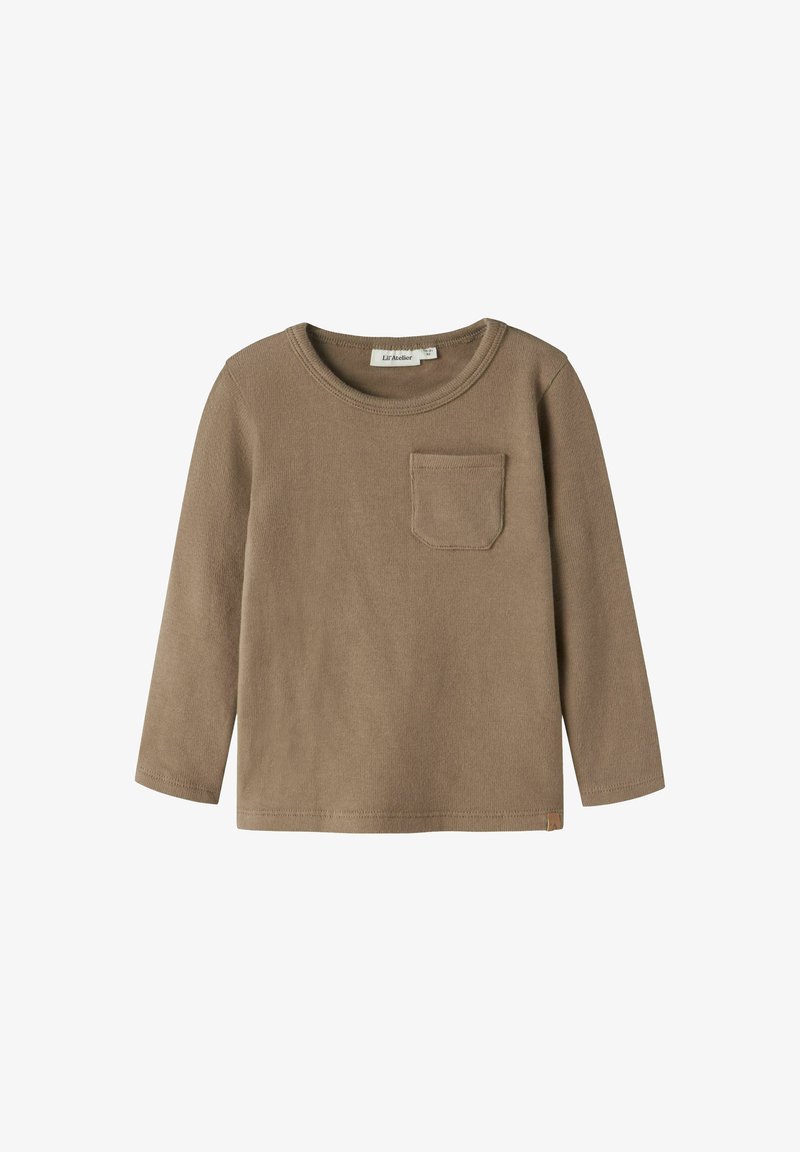 Pruun pikkade varrukatega T-särk, mis on valmistatud pehmest tekstureeritud kangast. Esimisel poolel on tasku ja ümmargune kaelus. Hemmikul on väike brändi silt.