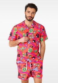 Short-sleeve, bright pink beach set featuring cartoon graphics of monsters and stairs; made of lightweight fabric with a drawstring waist.
