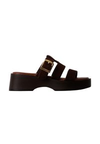 Sandale à plateforme marron foncé avec trois brides et une grande boucle dorée sur la bride du milieu, profil latéral visible sur fond blanc.