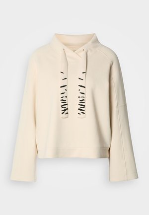 Krémovo sfarbený dlhý rukáv mikiny s širokým golierom a dvoma hrubými sťahovacími šnúrkami s čiernymi abstraktnými vzormi.