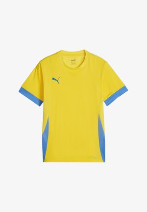 Dzeltena sporta t-krekls ar ziliem tīkla akcentiem uz piedurknēm un sāniem. Izceļas ar zilu Puma logo uz krūškurvja un apaļu dekoltē.