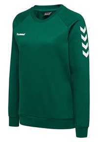 Sweat-shirt de sport vert à manches longues avec logo hummel blanc sur la poitrine et quatre chevrons blancs sur la manche droite.