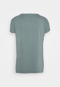 Short-sleeve, crew-neck t-shirt in a soft, muted teal color. Made of lightweight fabric with a smooth texture and slight stretch.