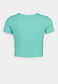 T-shirt court vert menthe en matière côtelée, avec manches courtes et col rond, ourlets cousus pour plus de durabilité.