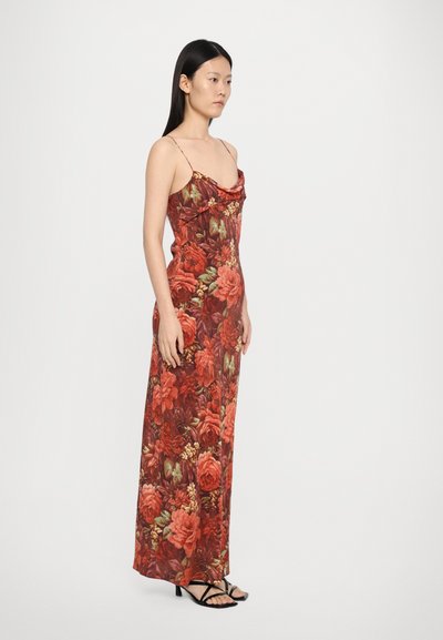 Floral maxi dress in rich red and green tones. Features thin straps, a ruffled neckline, and a fitted waist. Smooth, lightweight fabric.