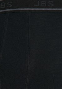 Black cotton boxer briefs featuring a textured waistband with "JBS" logo and subtle gray accent. Smooth fabric with vertical seams.