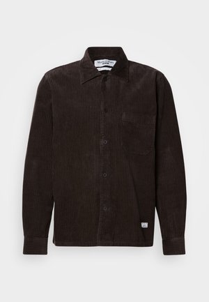 Brown corduroy shirt with a button-down collar, front pocket, and black buttons. Features vertical ribs and a subtle texture.