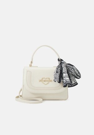 Cream handbag with gold "Love Moschino" logo, top handle, detachable strap, and black-and-white scarf with brand text tied to handle.