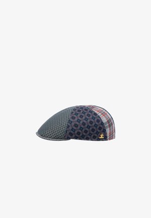 Flat cap with mixed blue-gray patterned fabrics including checks and dots, featuring a small gold emblem on the side.