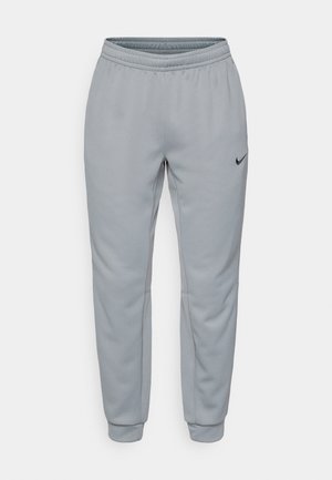 Grijze Nike-sweatpants hebben een rekbare tailleband, een taps toelopend ontwerp, zijzakken en een minimale zwarte logoaccent met een gladde textuur.